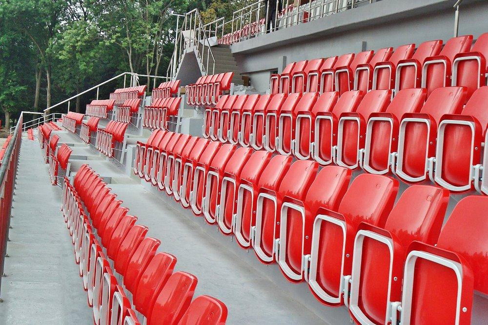 red tribune chairs - athletics stadium - folding seat - metal hanging galvanized structure