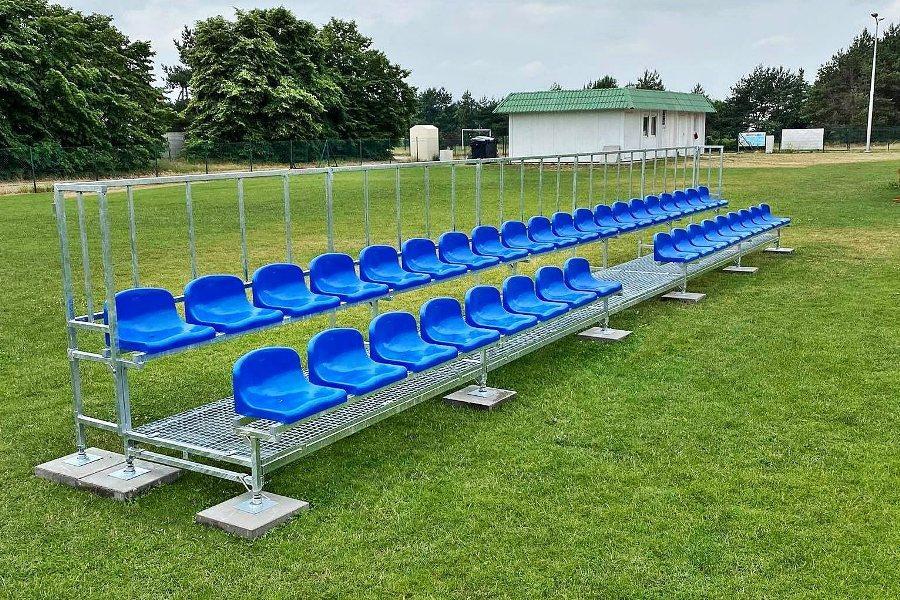 double-row metal bleachers with plastic chairs for small sports venues