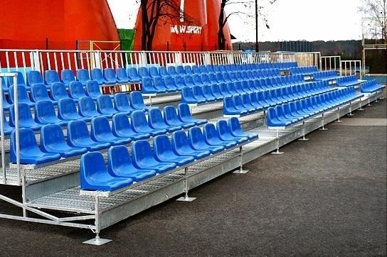 metal grandstands with blue high back stadium chairs for tennis courts