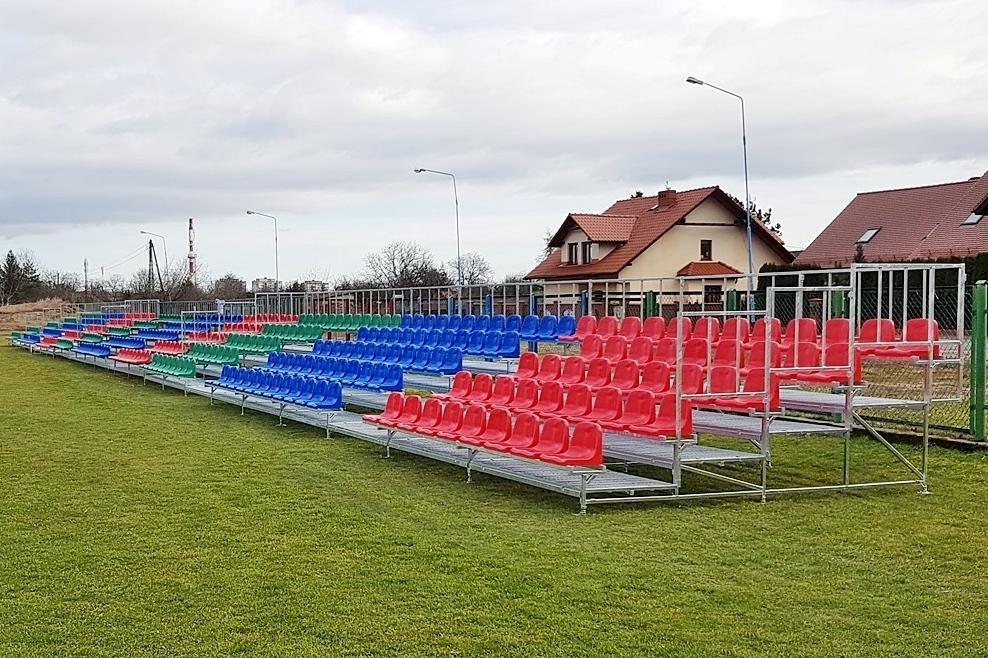 football stadium bleachers with red and blue chairs from the manufacturer
