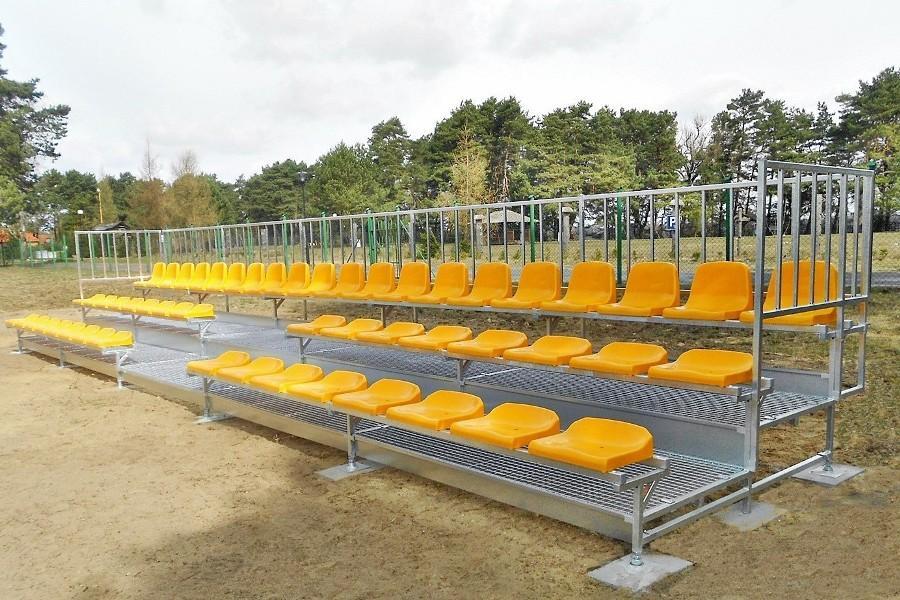 bleachers with yellow stadium seats for spectators