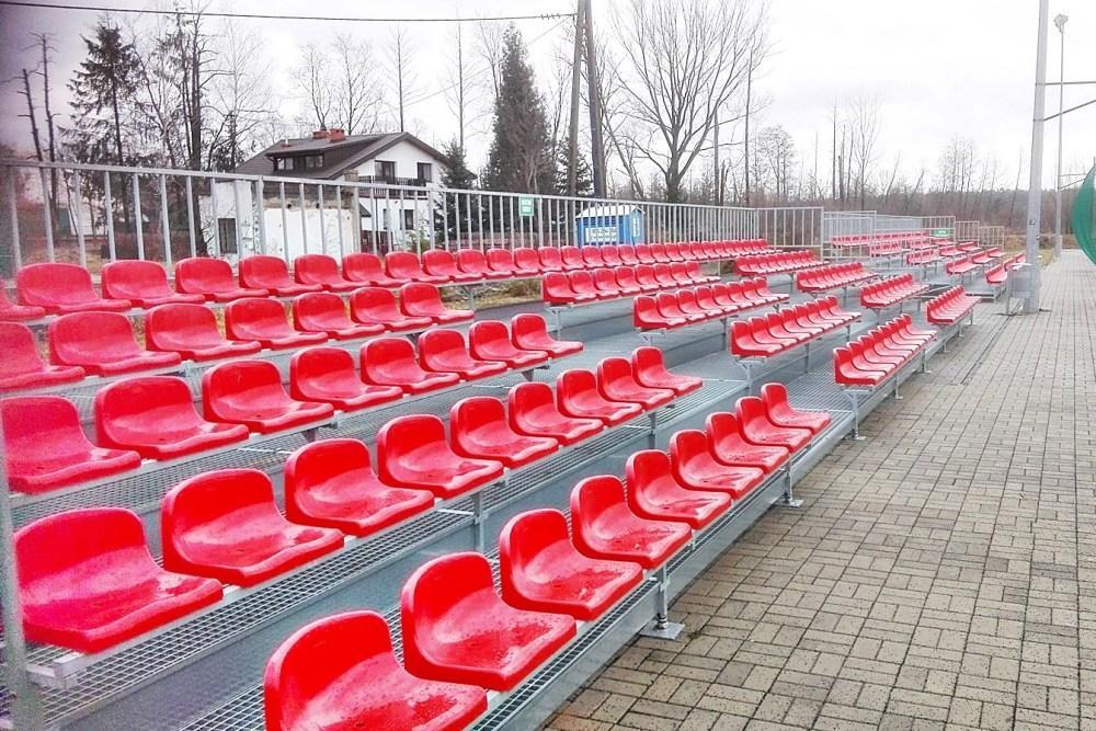 five row football stadium bleachers with red stadium chairs