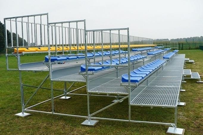 Solid metal bleachers with plastic chairs